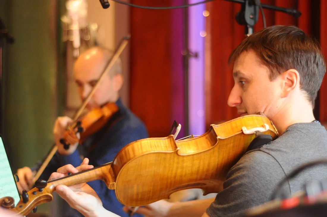 Violinists performing during the string quartet recording